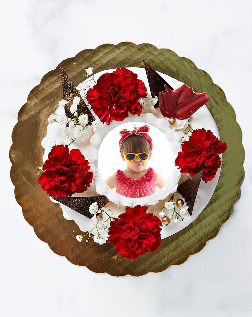 Top of cake with fresh red flowers and a picture of a girl in sunglasses