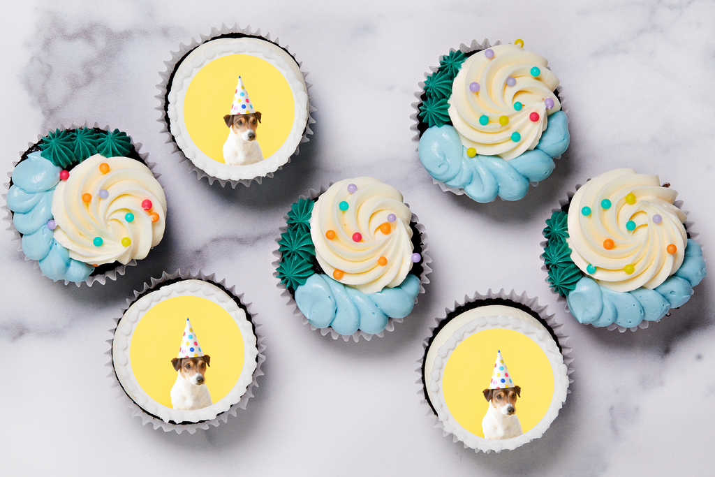 Cupcakes with a picture of a dog in a birthday hat