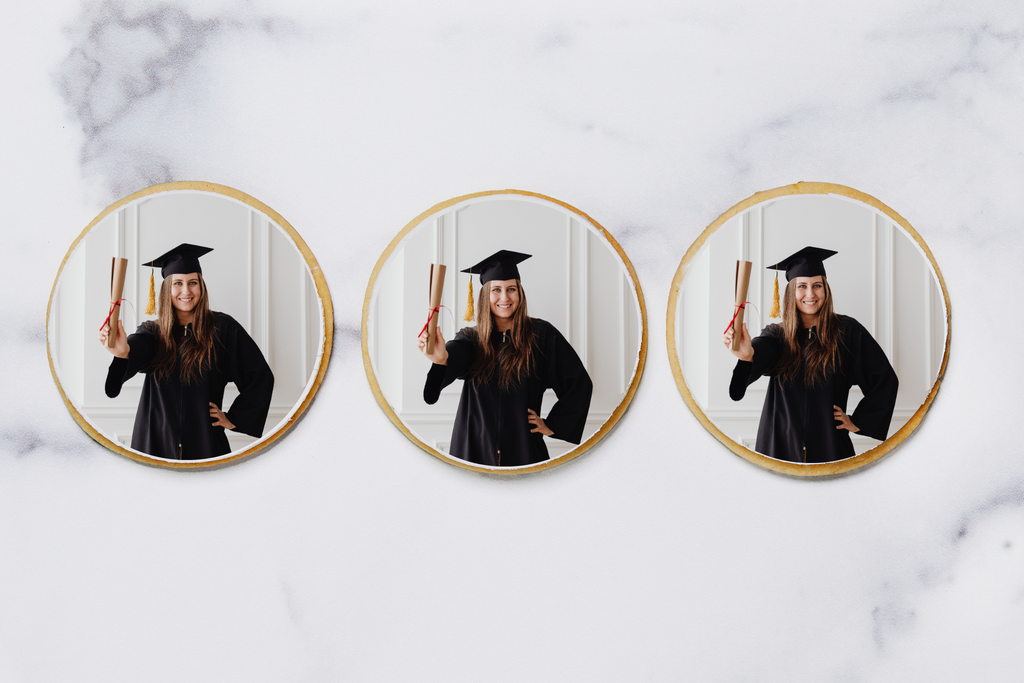 Three sugar cookies with graduation picture printed in frosting